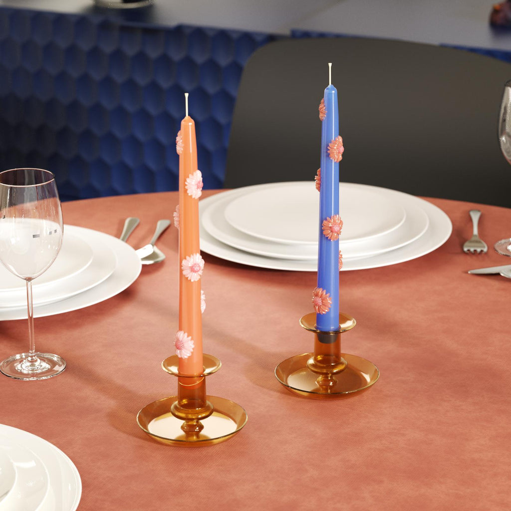 Brown glass candlesticks with daisy taper candles on the dining table-Boowan Nicole