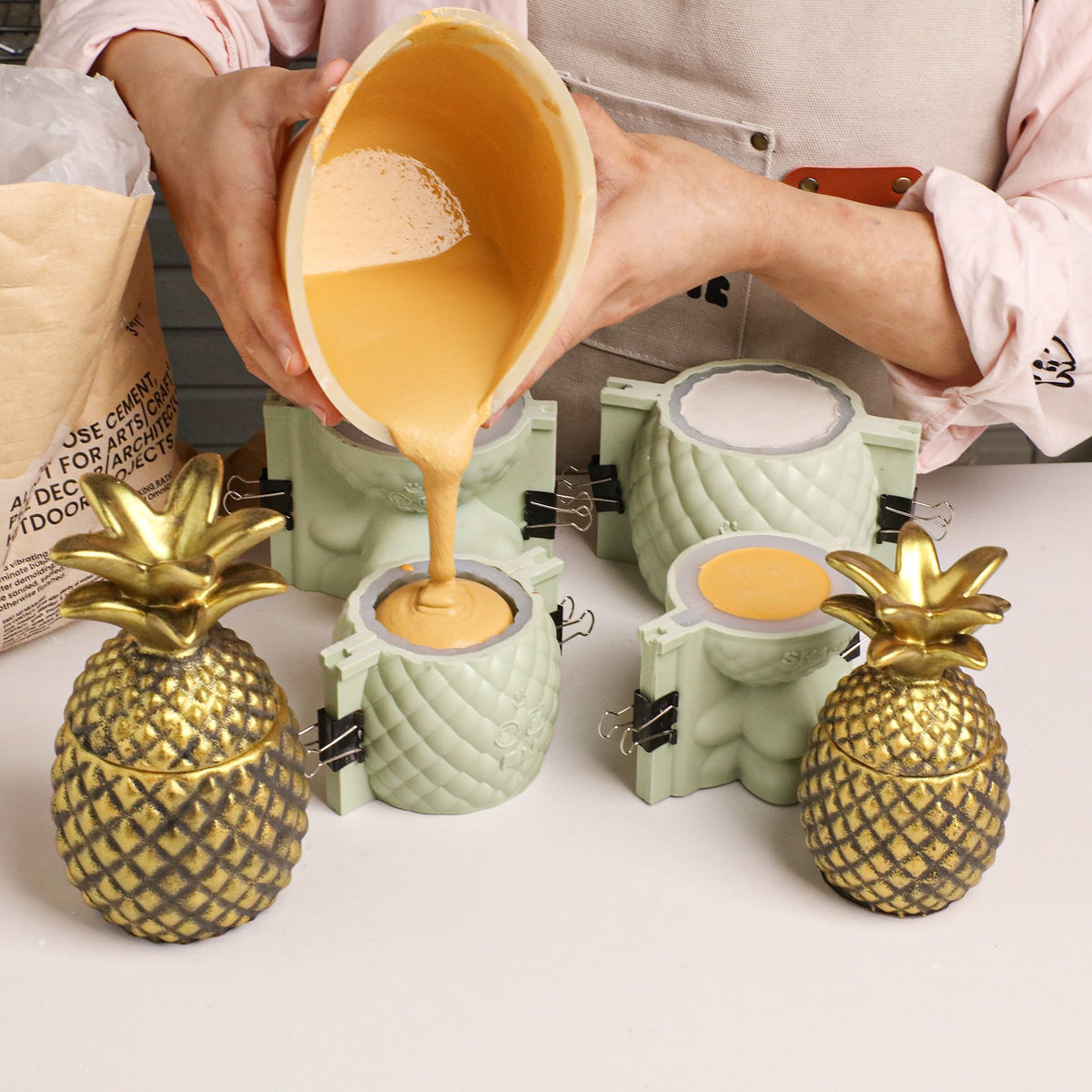 Pouring yellow cement into the pineapple jar silicone mold