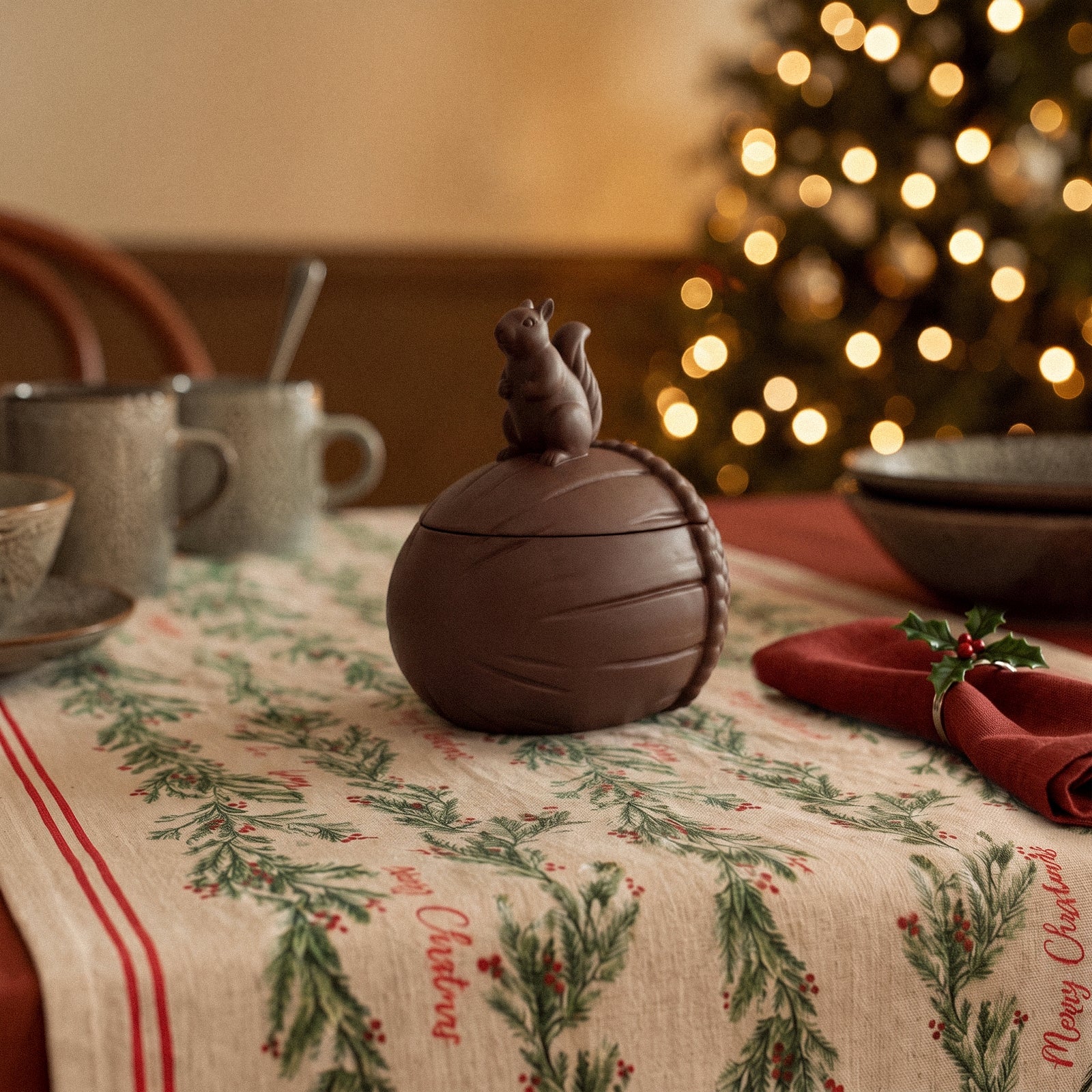 Woodland Nut Squirrel Candle Jar styled in a cozy woodland tablescape with pinecones and autumn leaves