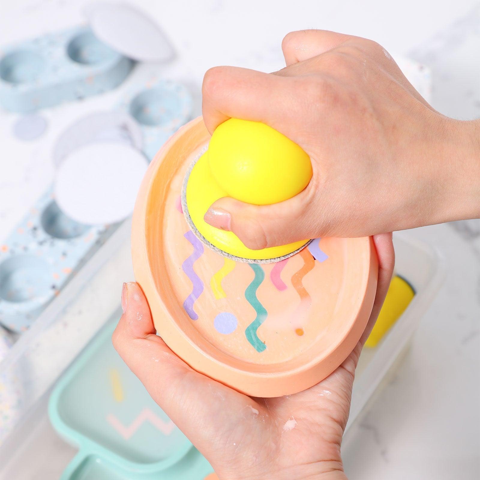 CraftPro Terrazzo Hand Sander, delicately polishing a small concrete plate for a refined shine.