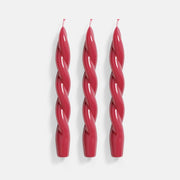 Three vibrant red spiral taper candles crafted with precision using Boowannicole's silicone molds