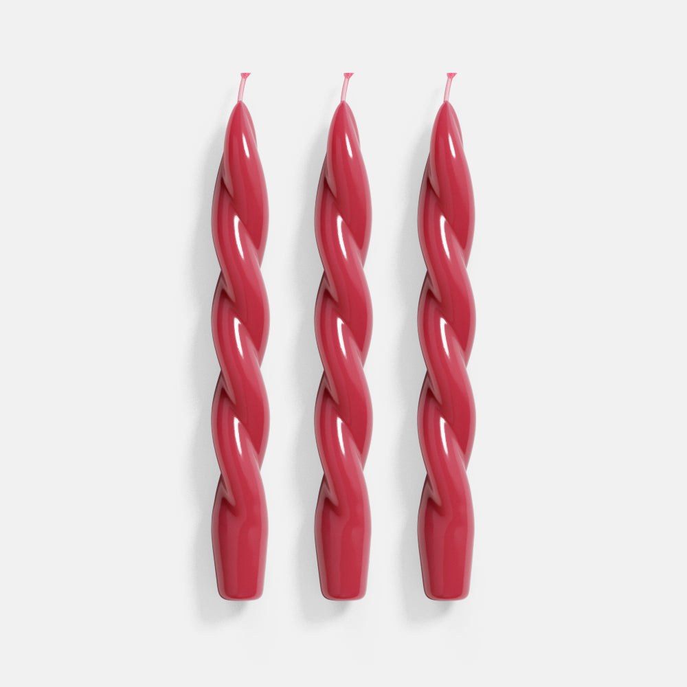 Three vibrant red spiral taper candles crafted with precision using Boowannicole's silicone molds