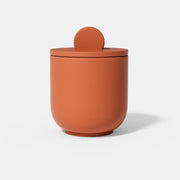 This is an orange candle jar with a handle, crafted using Boowannite material and Boowannicole silicone molds.