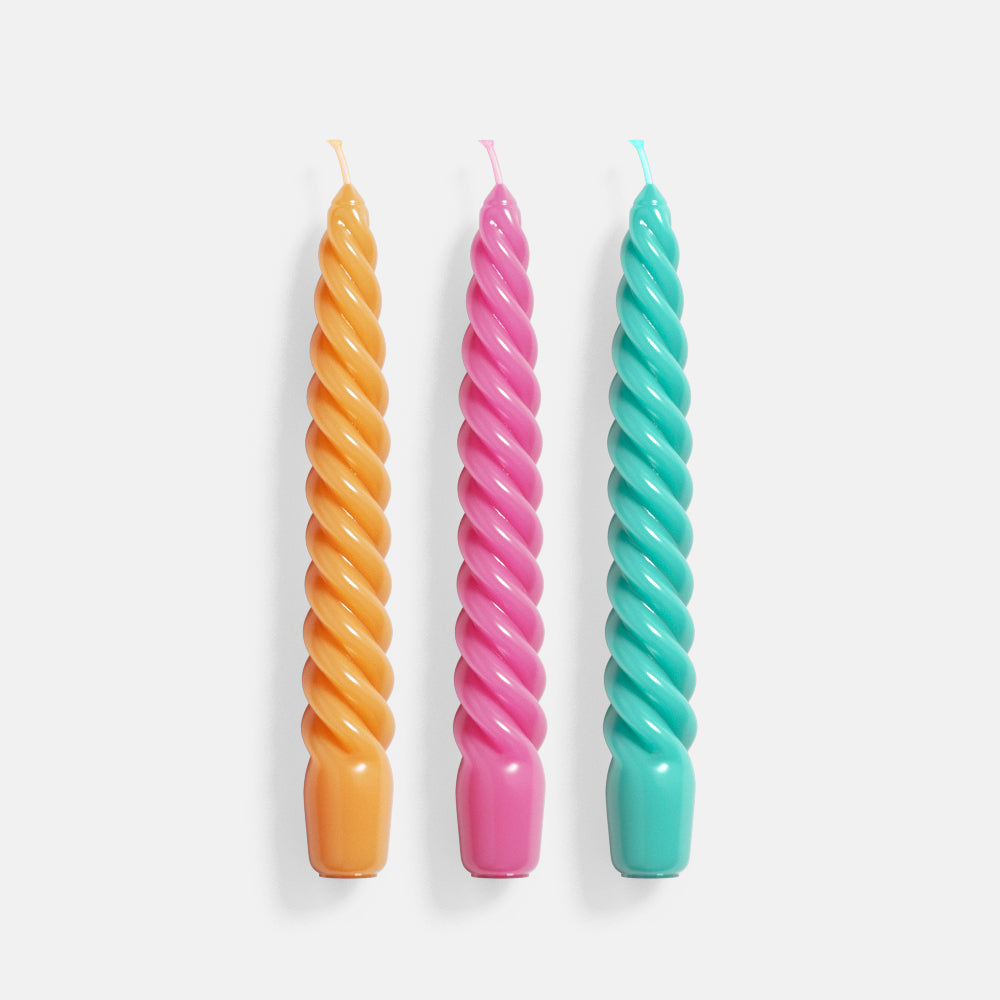 Three spiral cone-shaped candles crafted using Boowannicole silicone molds. Each candle exhibits a unique spiral pattern, with intricate details, showcasing the soft yet durable quality of the silicone molds.