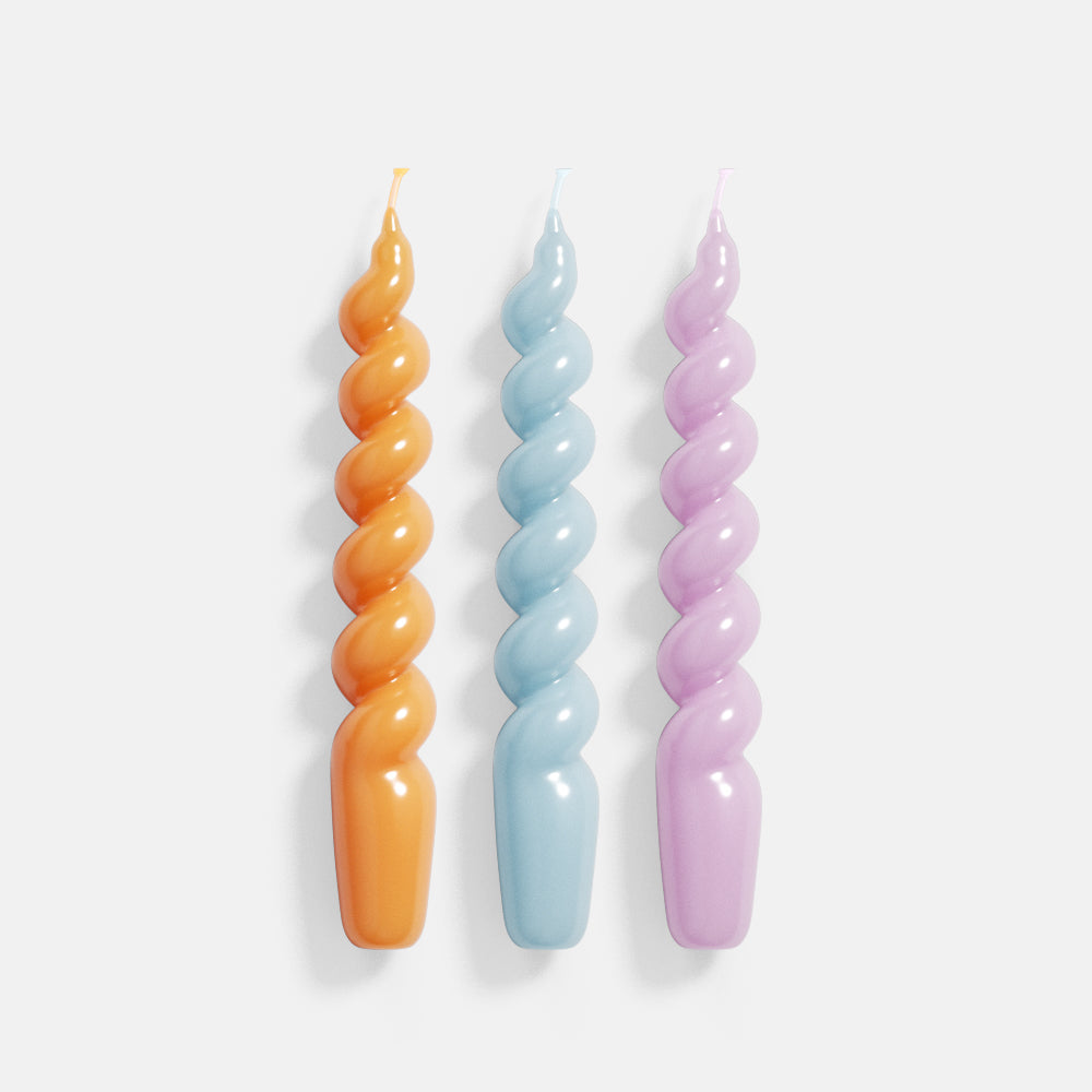 Three candles meticulously crafted with Boowannicole's silicone molds, each boasting vibrant hues of orange, blue, and purple, adding a unique artistic touch to the space.