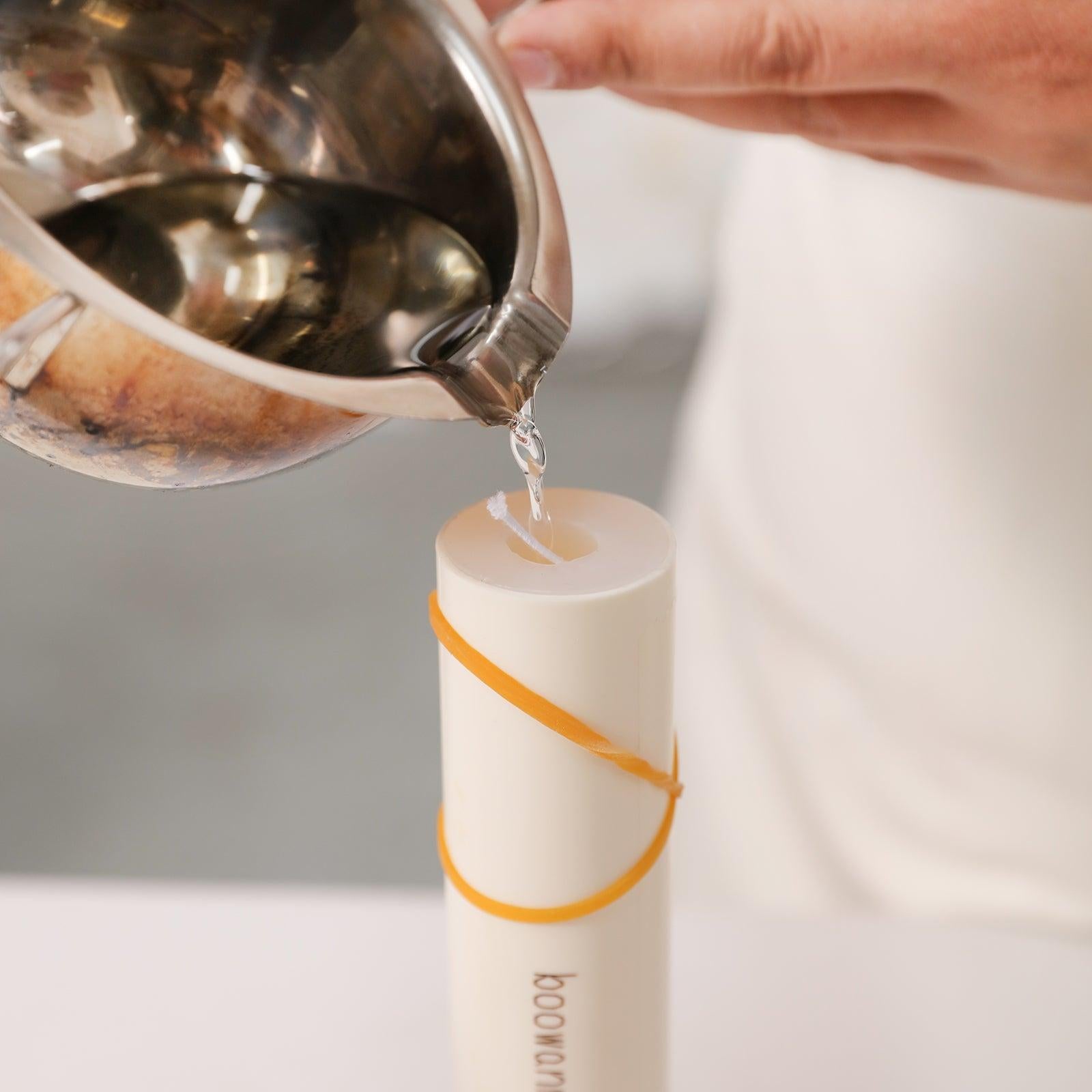 Pouring wax into Boowannicole's silicone molds to create stunning candles.