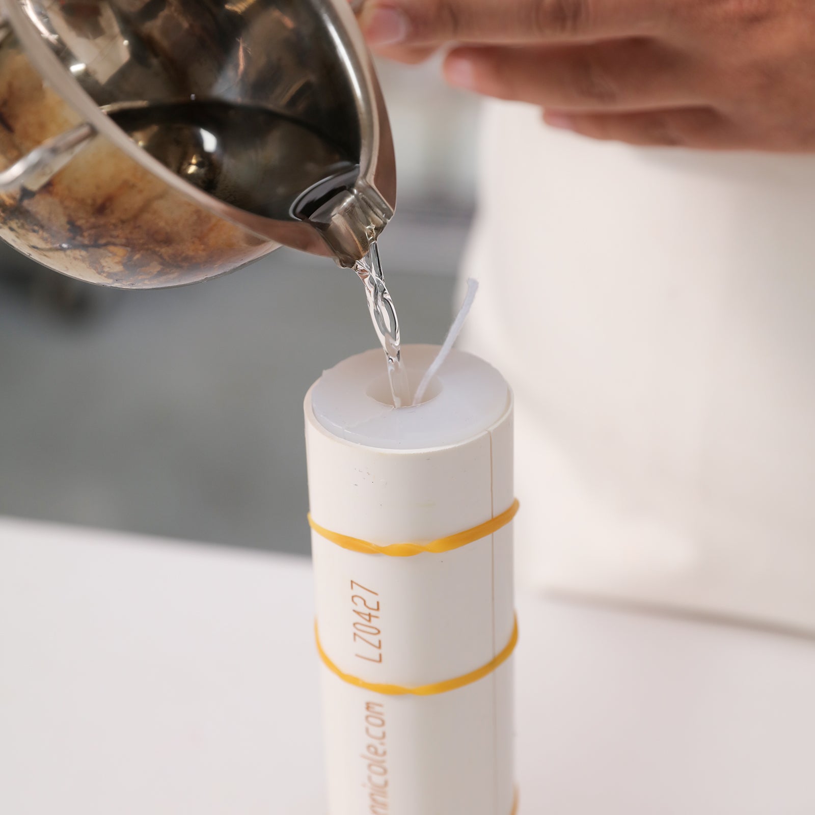 Pouring wax into Boowannicole's silicone molds