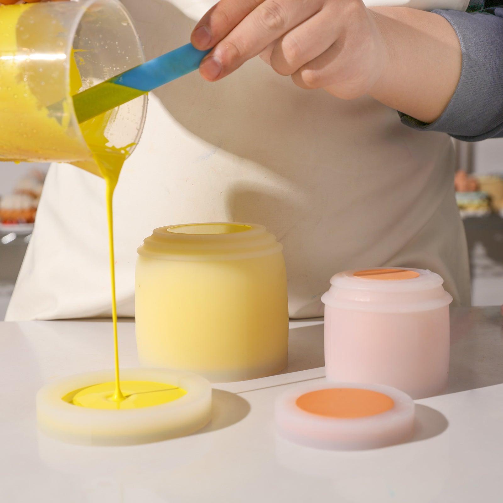 Boowannicole Silicone Molds: Small jar & lid in orange Boowannite, large jar in yellow, large lid pouring yellow Boowannite.