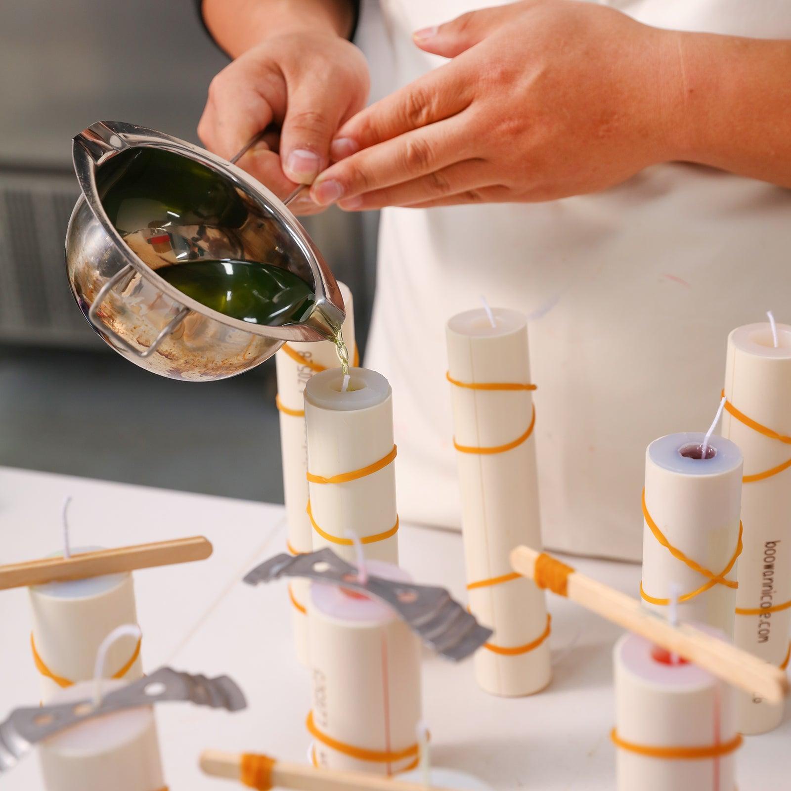Gently pouring liquid wax into Boowannicole silicone molds.