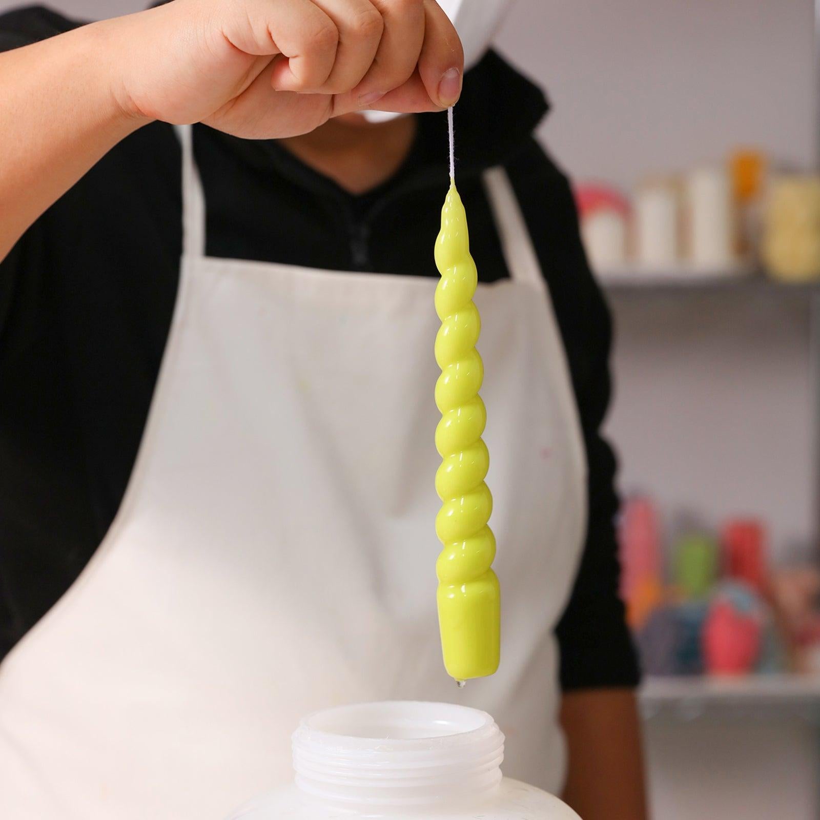 Witness the final touch of perfection as BOOWANNICOLE's exquisitely crafted candles are delicately immersed in wax, creating a captivating moment in the art of candle-making.