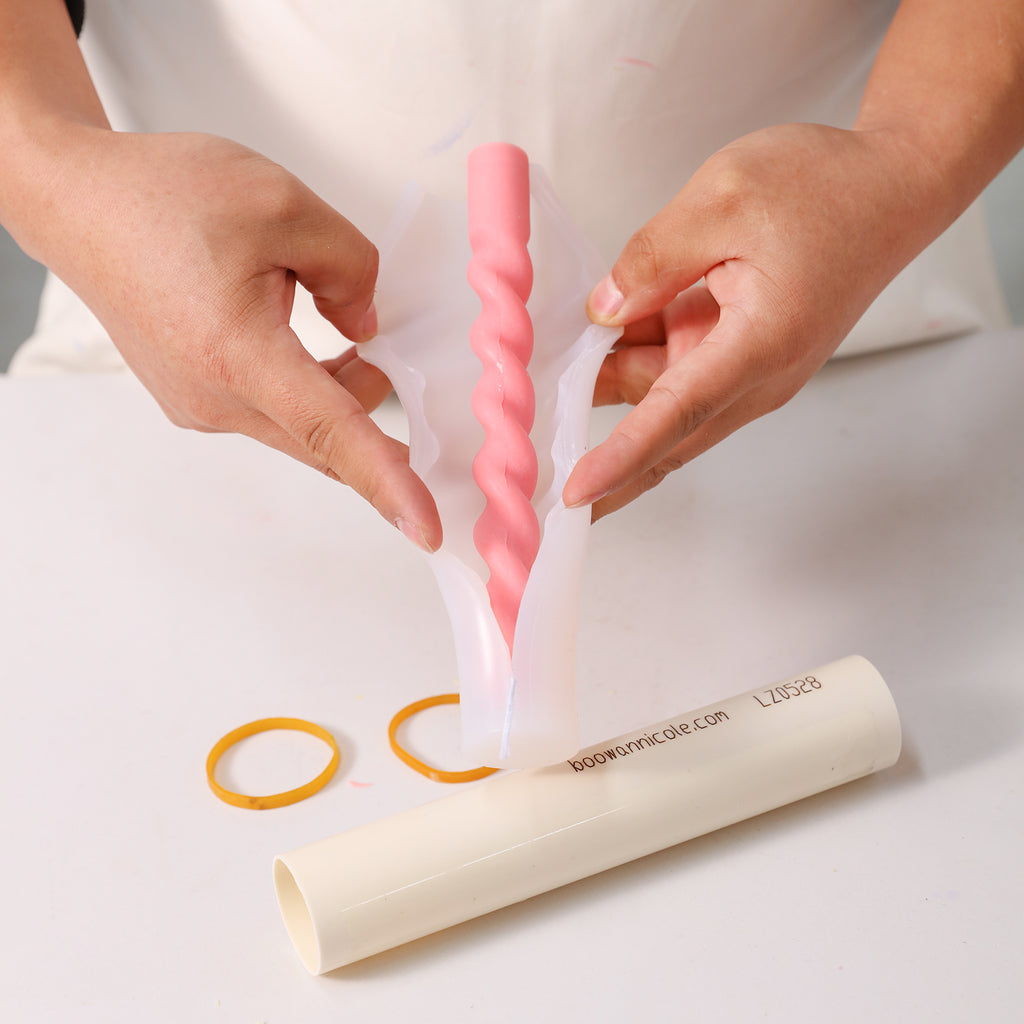 Unveiling Crafted Beauty - Experience the moment as perfectly formed cone candles are released from Boowannicole's silicone molds, showcasing precision in every detail.