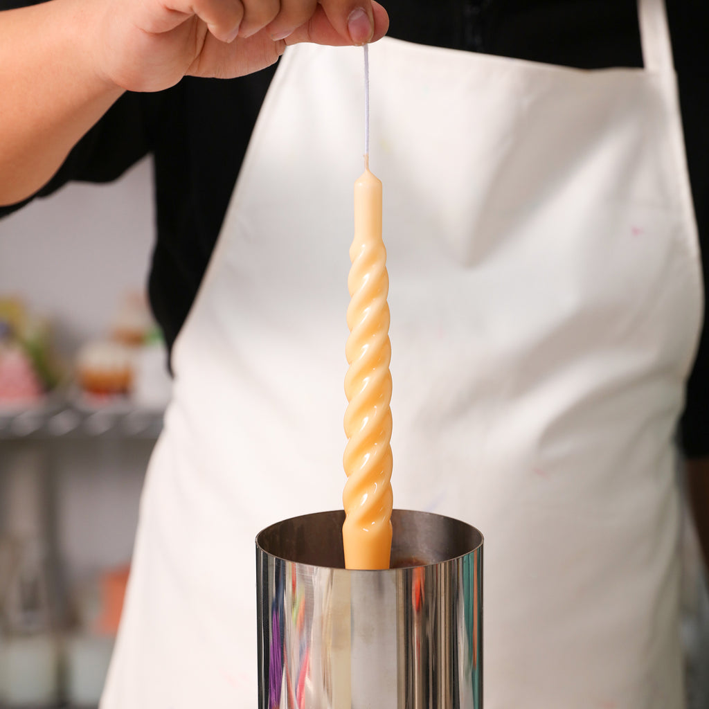 Dive into the process of candle crafting with Boowannicole – experience the moment as a Spiral Taper Candle gracefully immerses into molten wax.