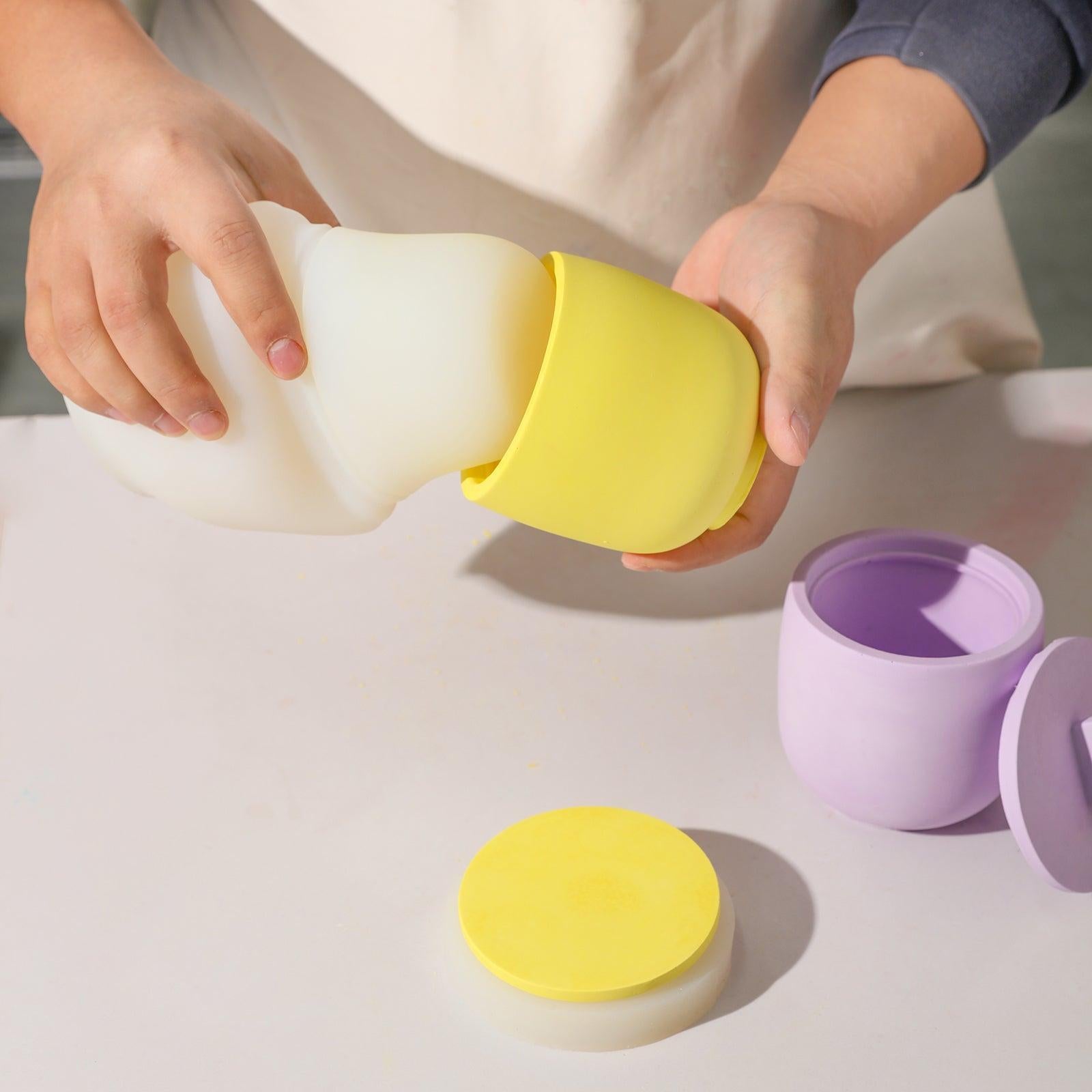 Boowannicole's Yellow Candle Jar emerging from silicone mold; adjacent lid, showcasing the brand's craftsmanship.