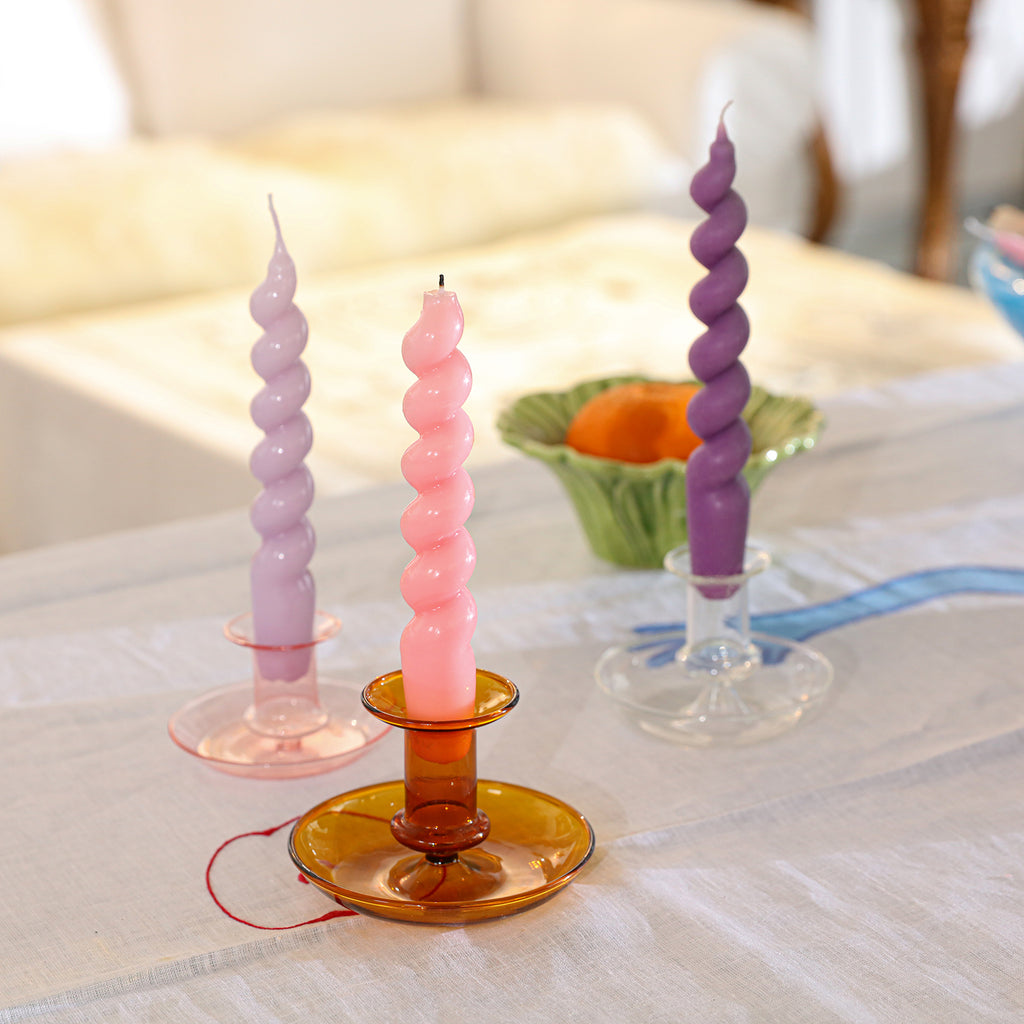 Three candles of different colors, meticulously crafted by Boowannicole, adorn the table, infusing the space with a unique artistic ambiance.
