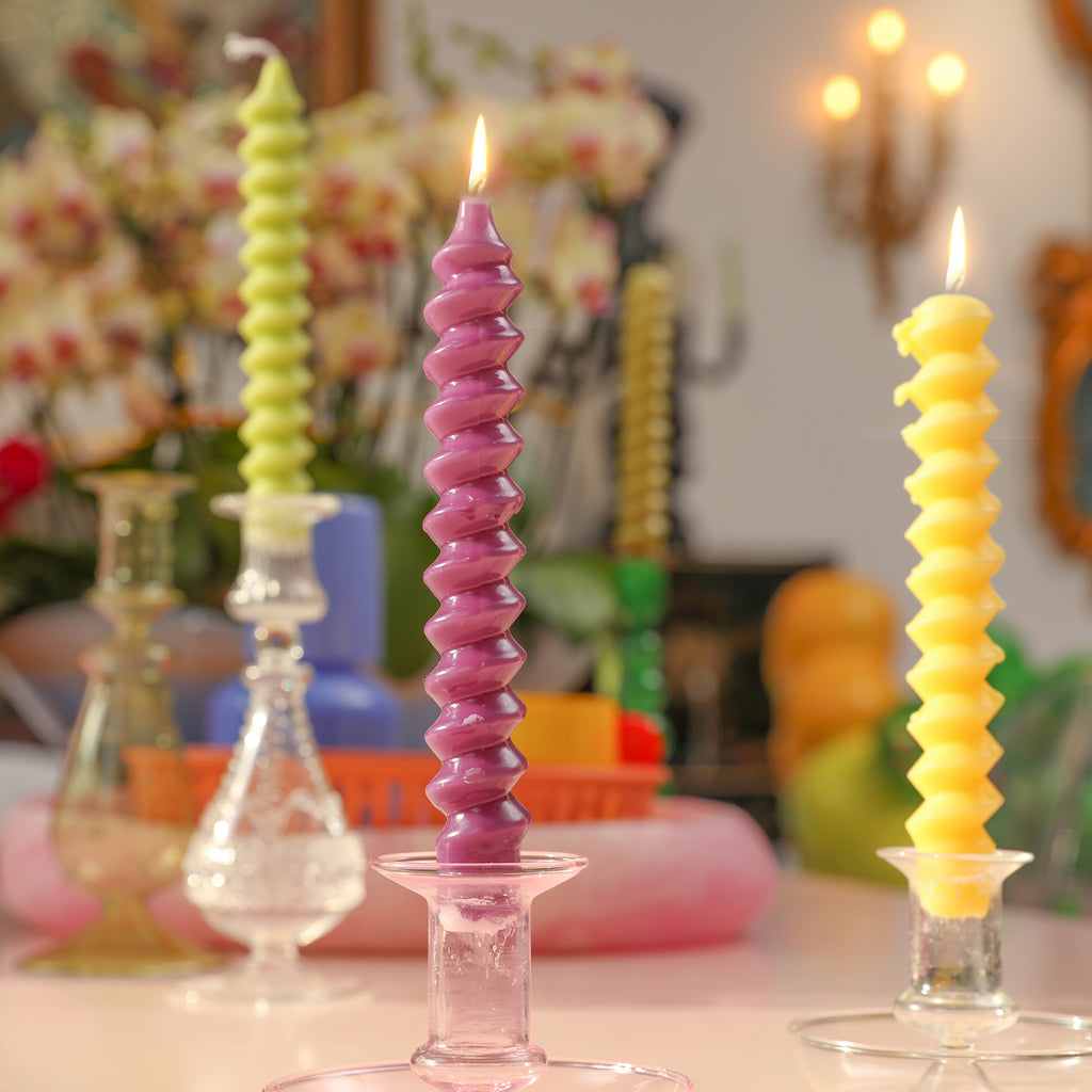 Candles crafted with Boowannicole's silicone molds, elegantly lit and placed on a glass candle holder.