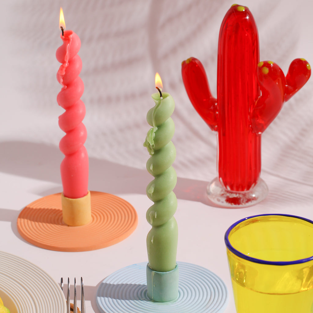 Two burning candles crafted with precision using Boowannicole's silicone molds.