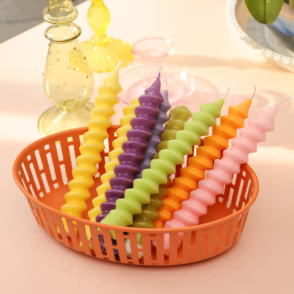 Taper candles placed in a plastic basket, crafted with boowannicole molds.