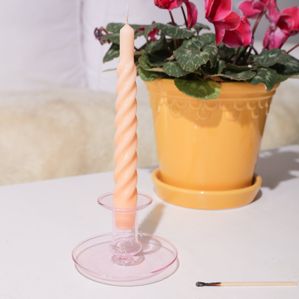Enhance your outdoor ambiance with Boowannicole's Spiral Taper Candle, elegantly placed on a candle holder beside a flower pot, adding a touch of charm to your surroundings