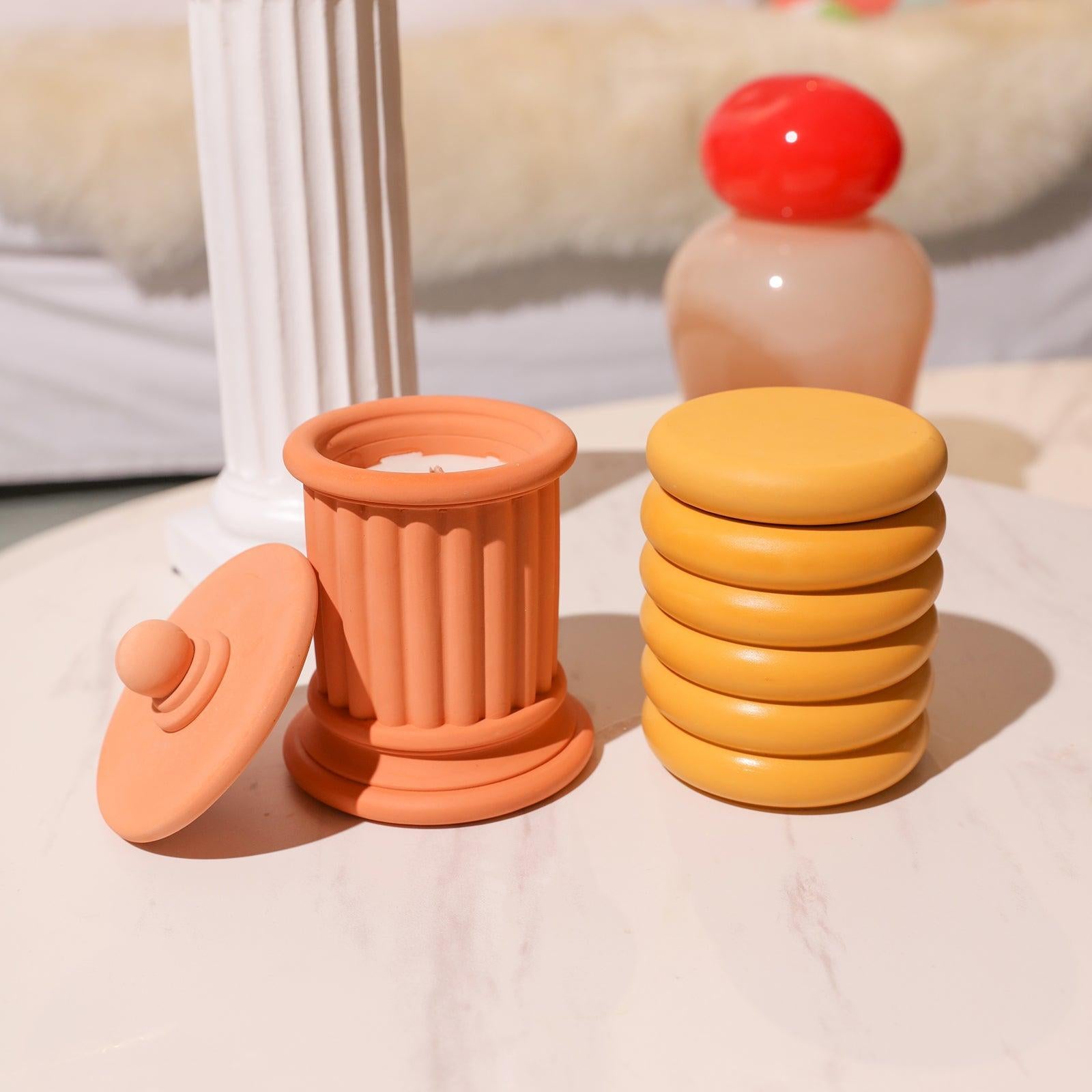 Two Boowannicole candle jars elegantly placed on the table. Harmonizing unique designs create a cozy and tranquil ambiance.