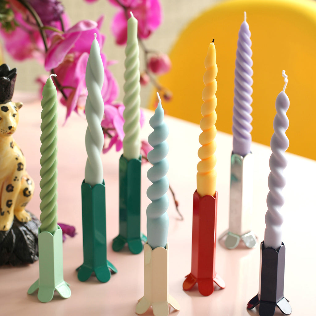 Static showcase of tapered candles in various shapes and colors, embodying the diverse artistry of Boowannicole.