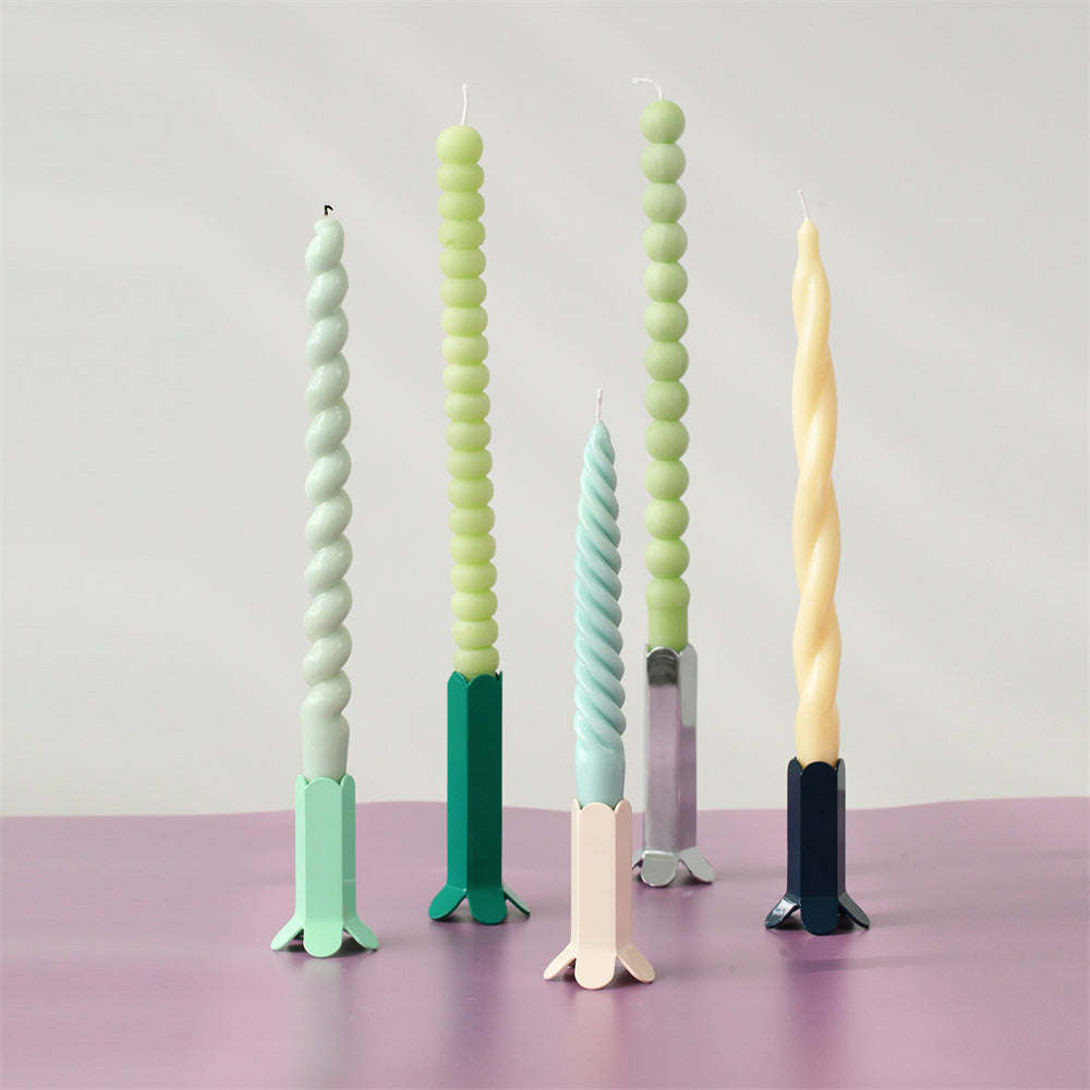 Spiral taper candles in various colors and designs crafted with Boowannicole silicone molds.