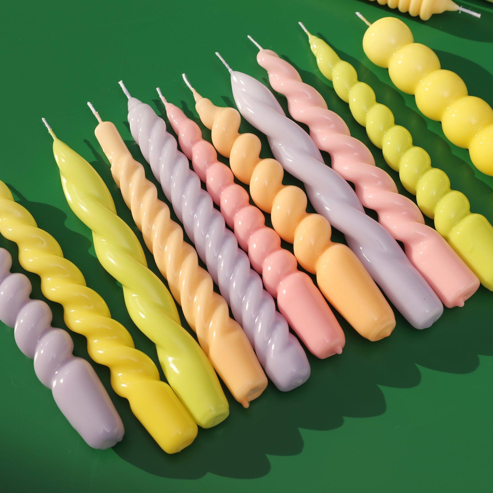 Explore a spectrum of creativity with Boowannicole's assorted candles, showcasing various colors and shapes to infuse your space with personalized charm.