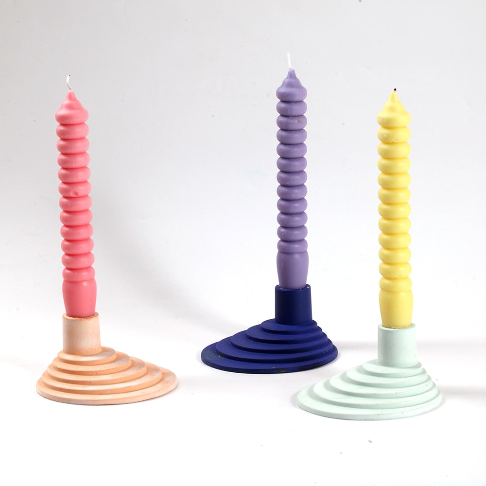 Elevate your decor with Boowannicole's trio of Spiral Taper Candles – red, purple, and yellow – delicately placed on stylish candle holders for a captivating ambiance.