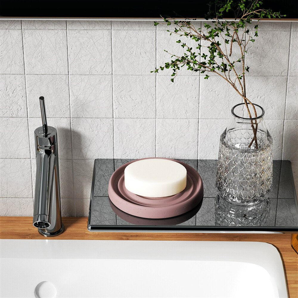 Brown circular concrete soap dish with soap placed next to the bathroom sink, creating a warm home atmosphere by boowannicole.