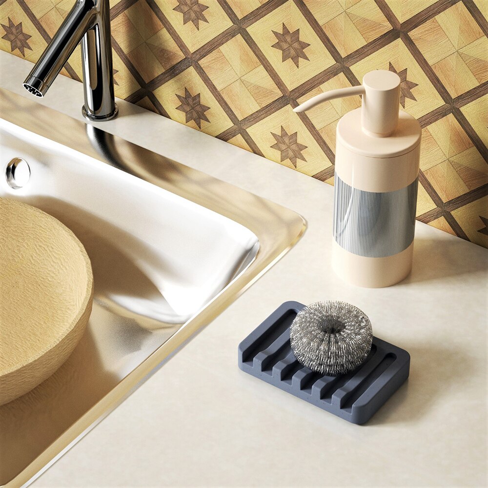 Grey rectangular concrete soap dish placed next to the bathroom sink, showcasing boowannicole's practicality in home decor.